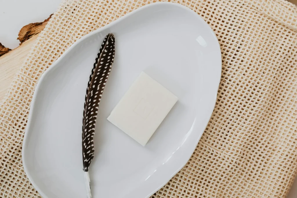 White solid shampoo bar in a dish.